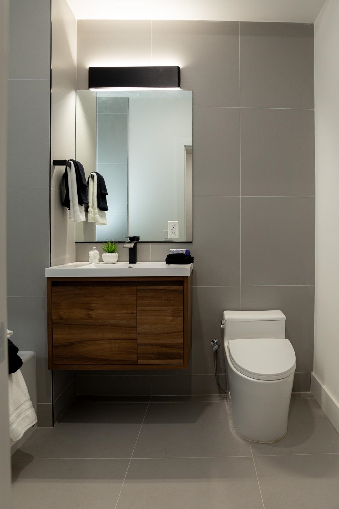 39 Boyd Avenue Jersey City, NJ 07304 - Photo 11 of 29 a bathroom with a toilet a sink and mirror