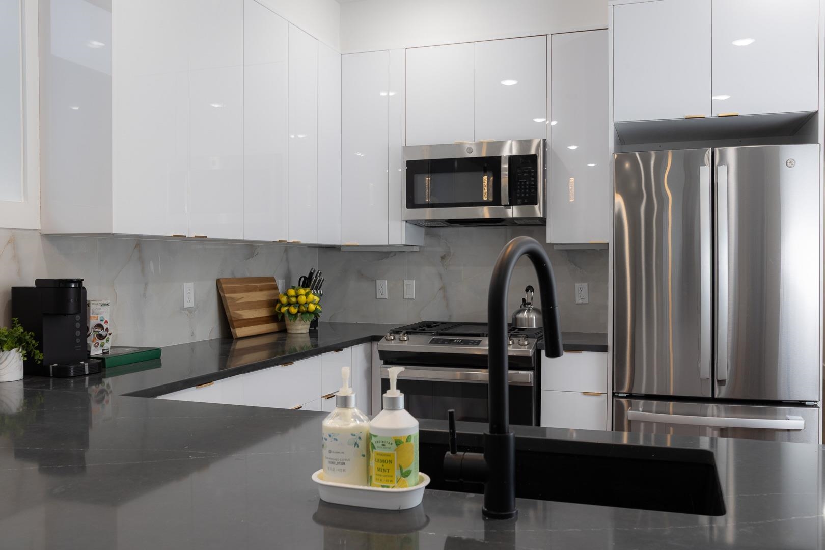 39 Boyd Avenue Jersey City, NJ 07304 - Photo 13 of 29 a kitchen with stainless steel appliances kitchen island granite countertop a stove and a sink with granite countertops