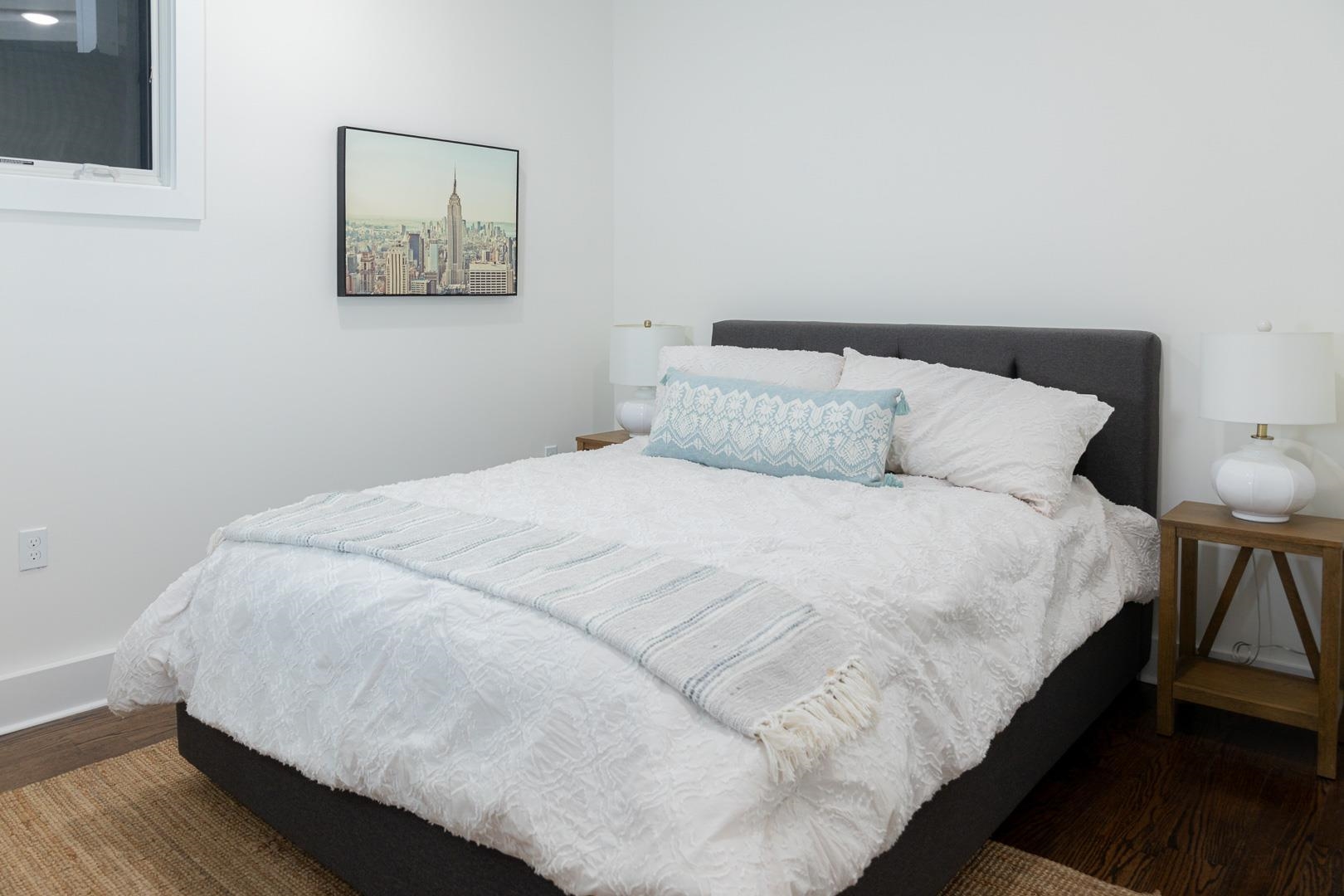 39 Boyd Avenue Jersey City, NJ 07304 - Photo 22 of 29 a large bed sitting in a bedroom next to a lamp