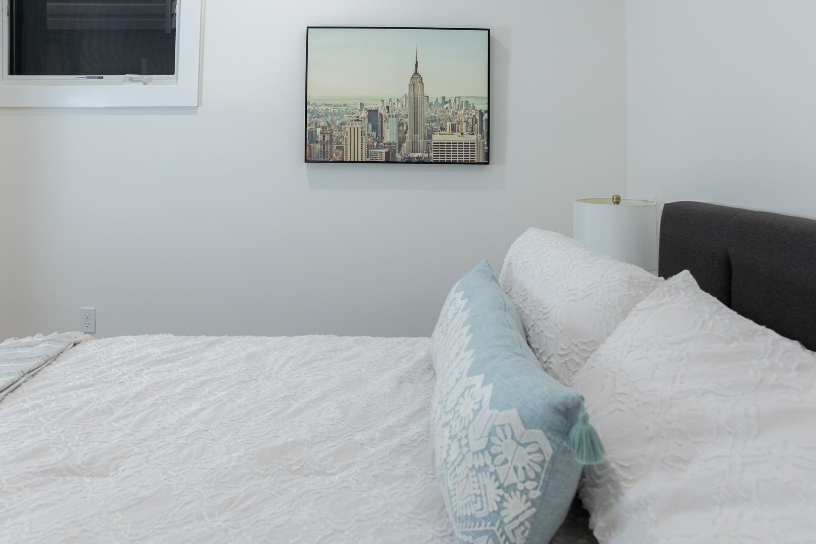 39 Boyd Avenue Jersey City, NJ 07304 - Photo 23 of 29 a bedroom with a bed and a wall painting