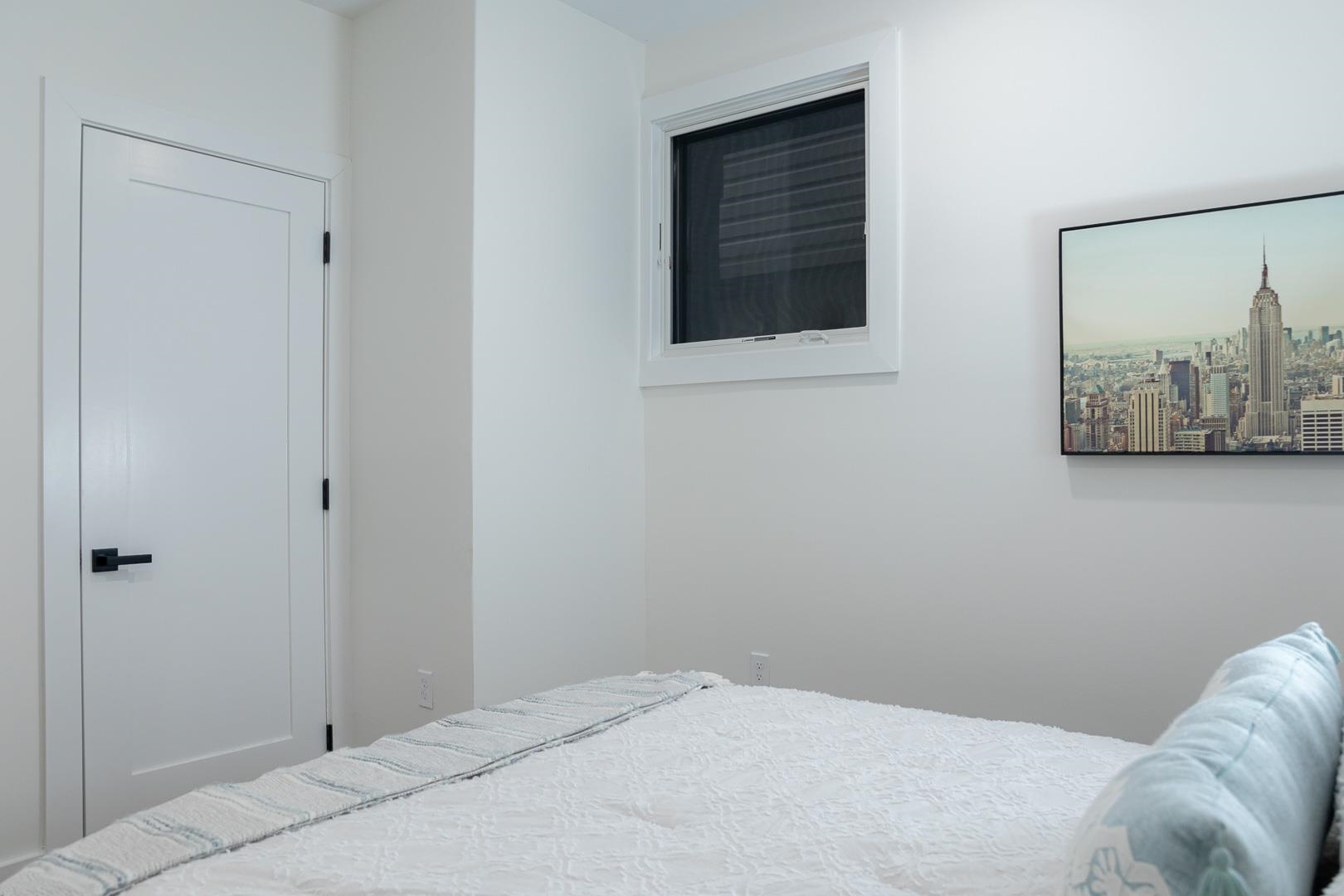 39 Boyd Avenue Jersey City, NJ 07304 - Photo 24 of 29 a bedroom with a bed and wall painting