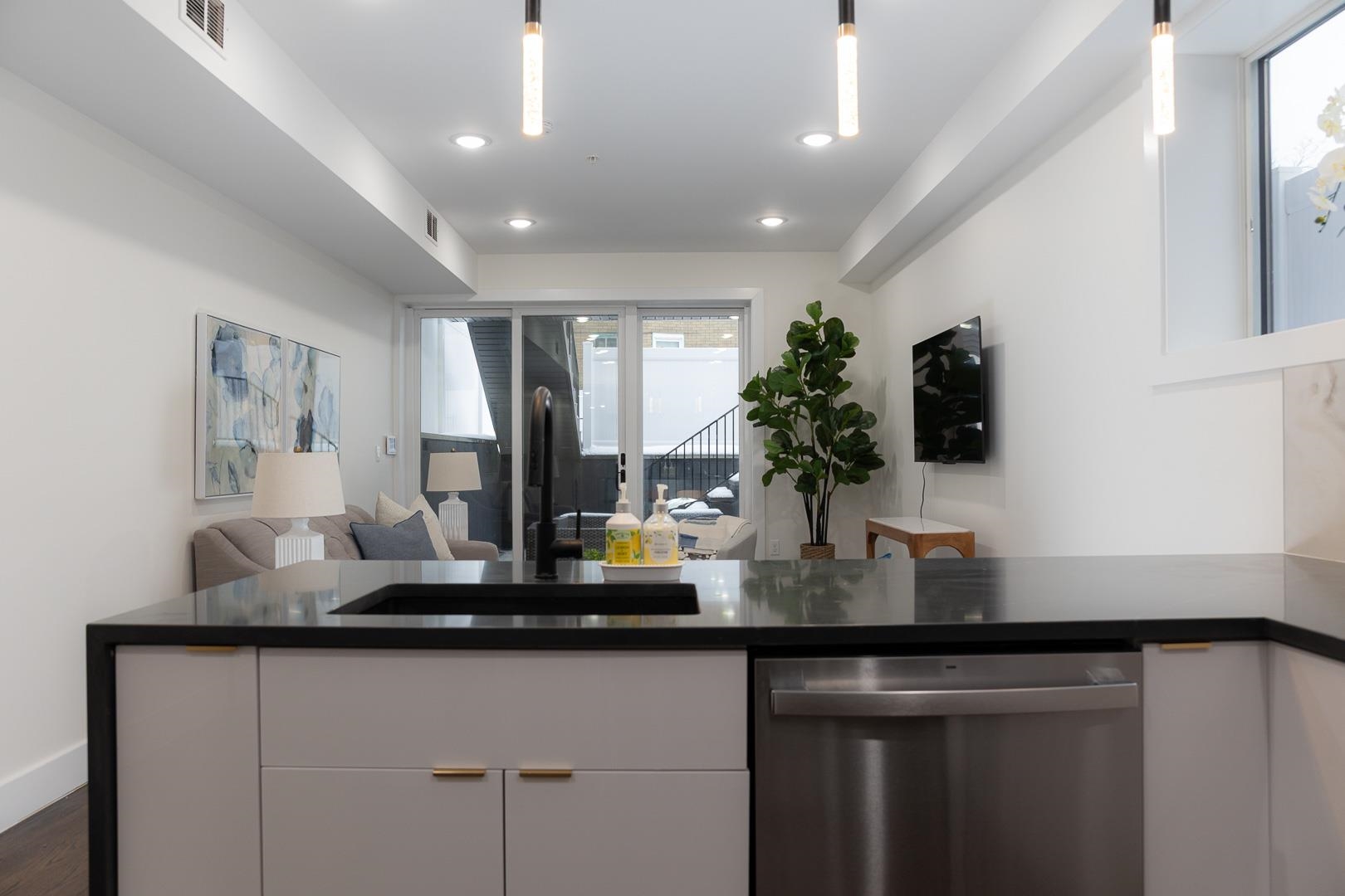 39 Boyd Avenue Jersey City, NJ 07304 - Photo 5 of 29 a kitchen with sink a counter top space and cabinets