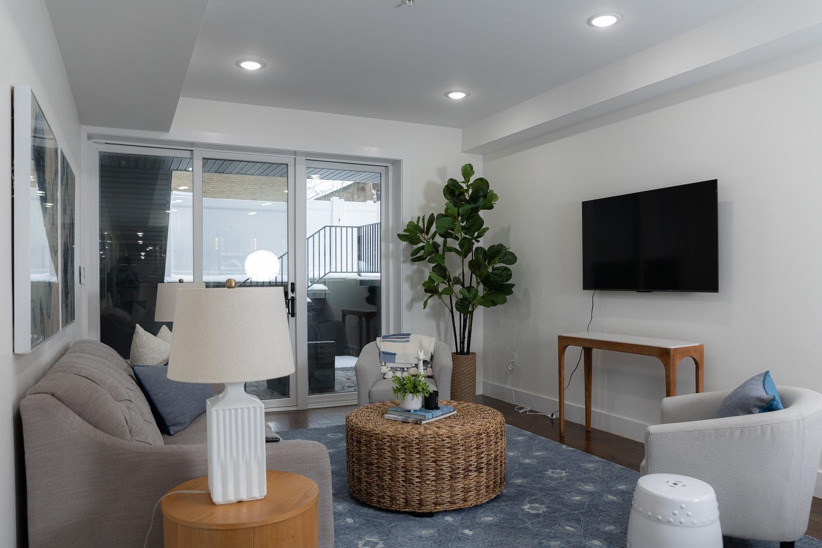 39 Boyd Avenue Jersey City, NJ 07304 - Photo 6 of 29 a living room with furniture and a flat screen tv