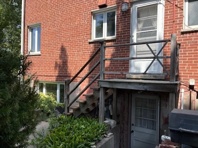 a view of house with backyard and glass windows