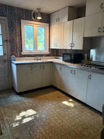 a kitchen with a sink cabinets and window