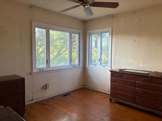a room with a dresser and a window