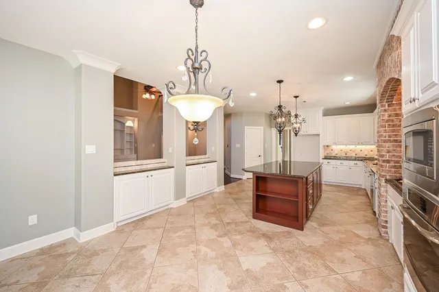 a living room with stainless steel appliances kitchen island granite countertop furniture and a view of kitchen