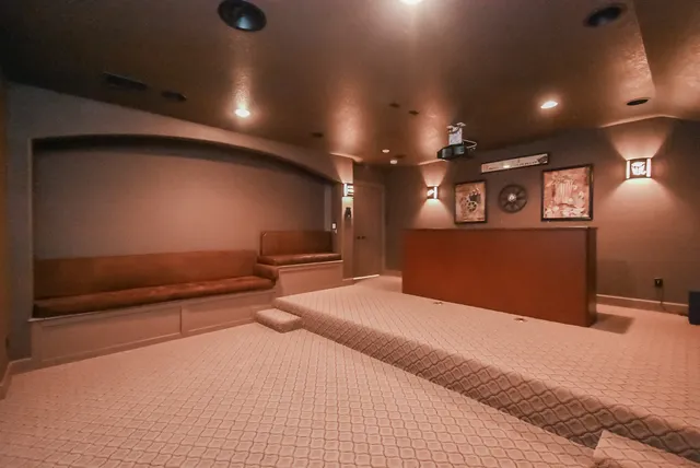 a bedroom with a bed and a large mirror with potted plants