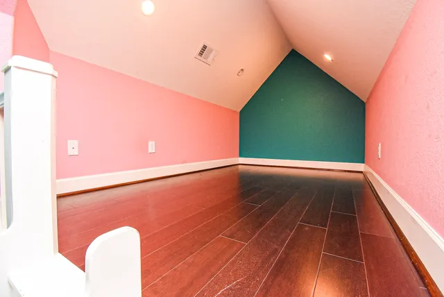 a view of a room with wooden floor