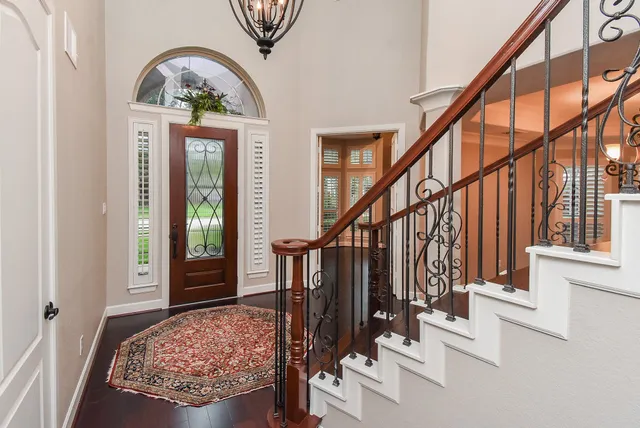 a view of an entryway with wooden floor and a rug