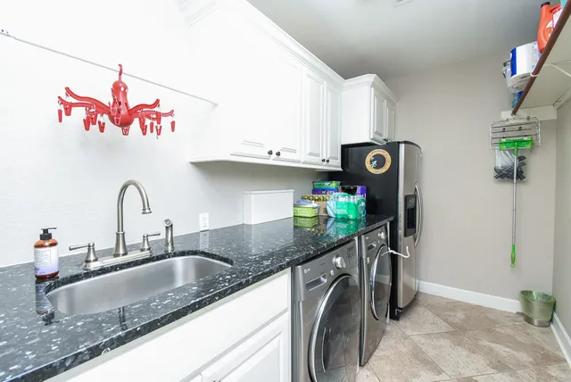 a kitchen with stainless steel appliances granite countertop a sink and a stove