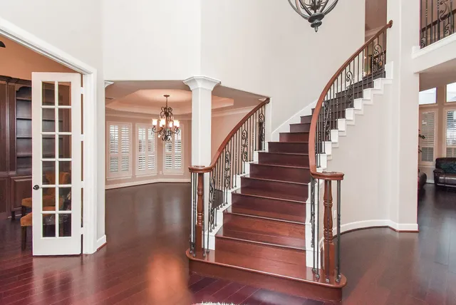 a view of staircase with white walls and windows