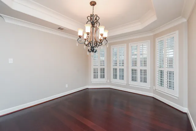 a view of wooden floor and windows in an empty room