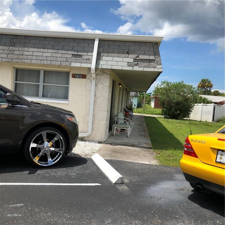 a view of a back yard of the house and car parked