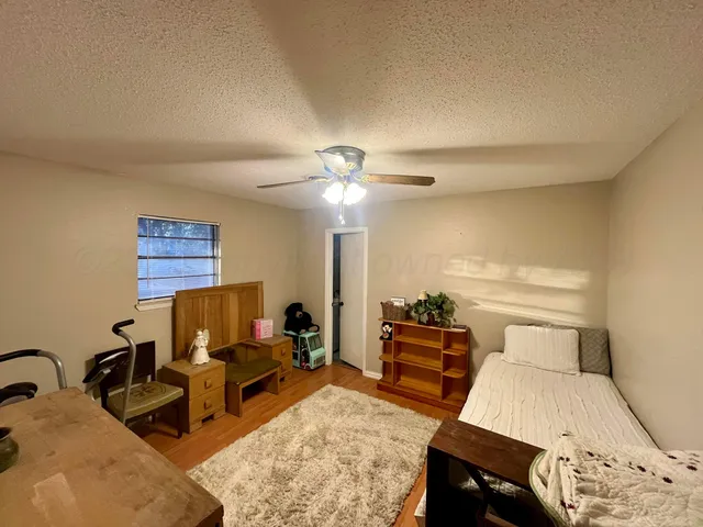 a living room with furniture and a lamp