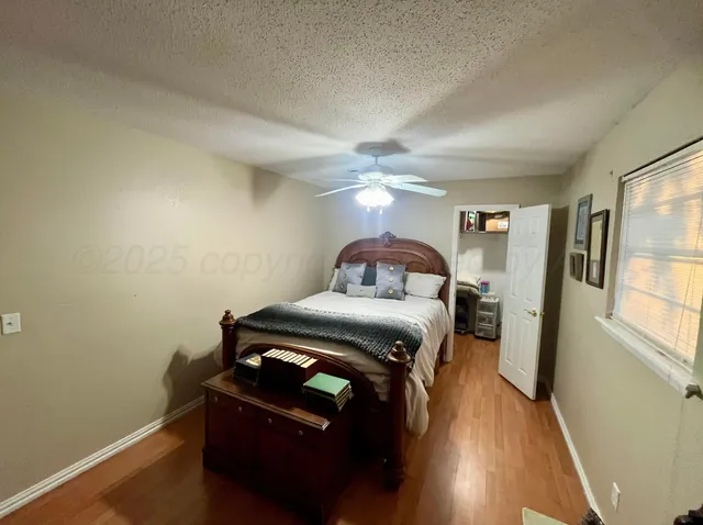 a living room with a bed furniture and a window