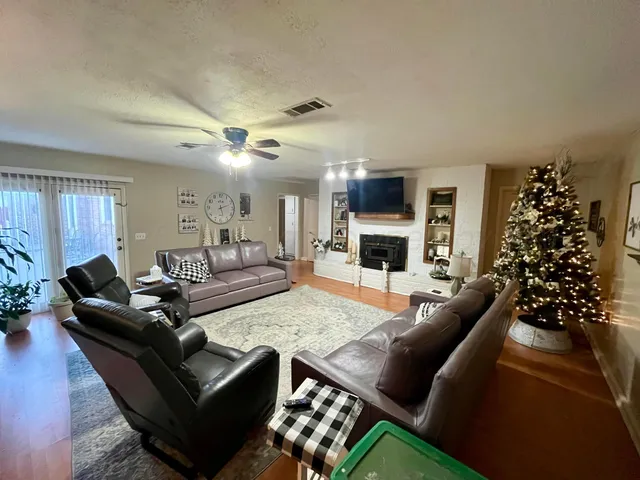a living room with furniture fireplace and a window