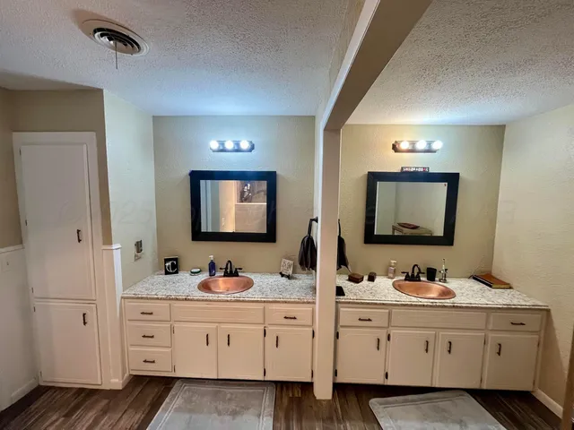 a bathroom with double sink and a mirror