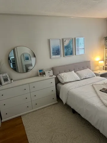 a bedroom with a bed and a dresser