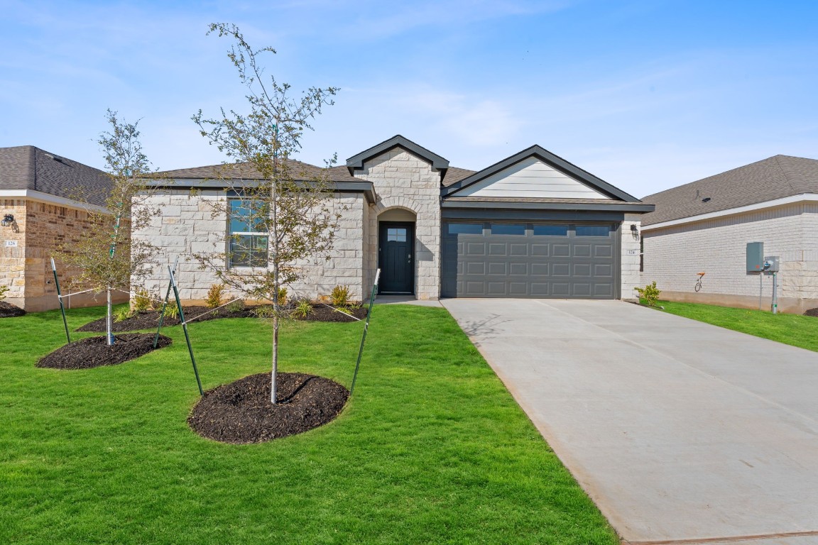 124 Bruin Paw Drive Georgetown, TX 78628 - Photo 1 of 18 a front view of a house with a yard and garage