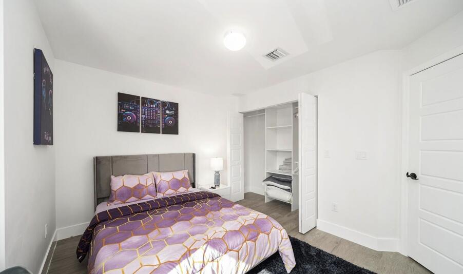 3254 Southwest 44th Street Fort Lauderdale, FL 33312 - Photo 15 of 26 a bedroom with a bed and a cabinets