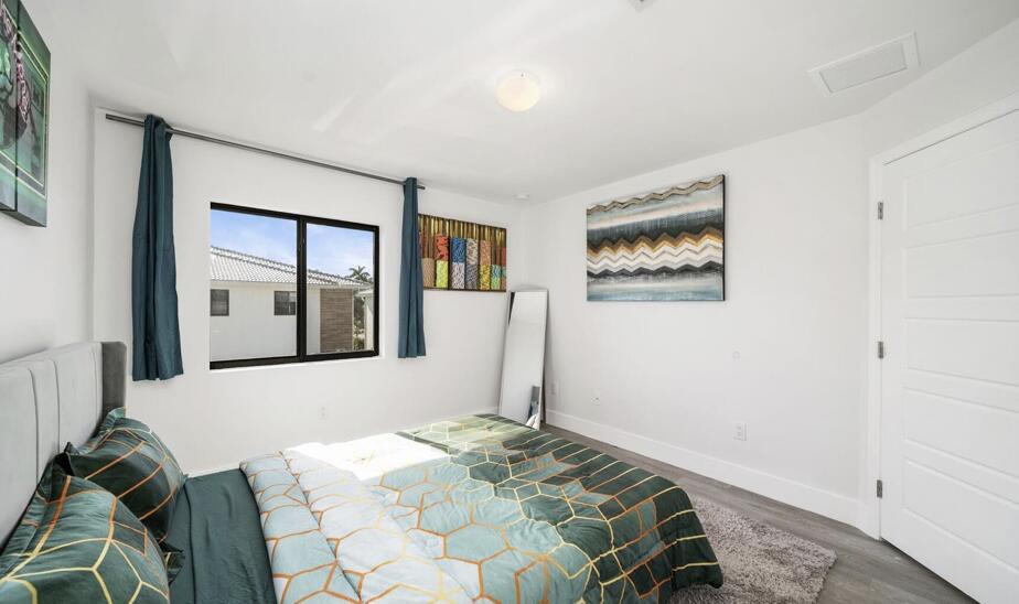 3254 Southwest 44th Street Fort Lauderdale, FL 33312 - Photo 17 of 26 a bed sitting in a bedroom next to a window