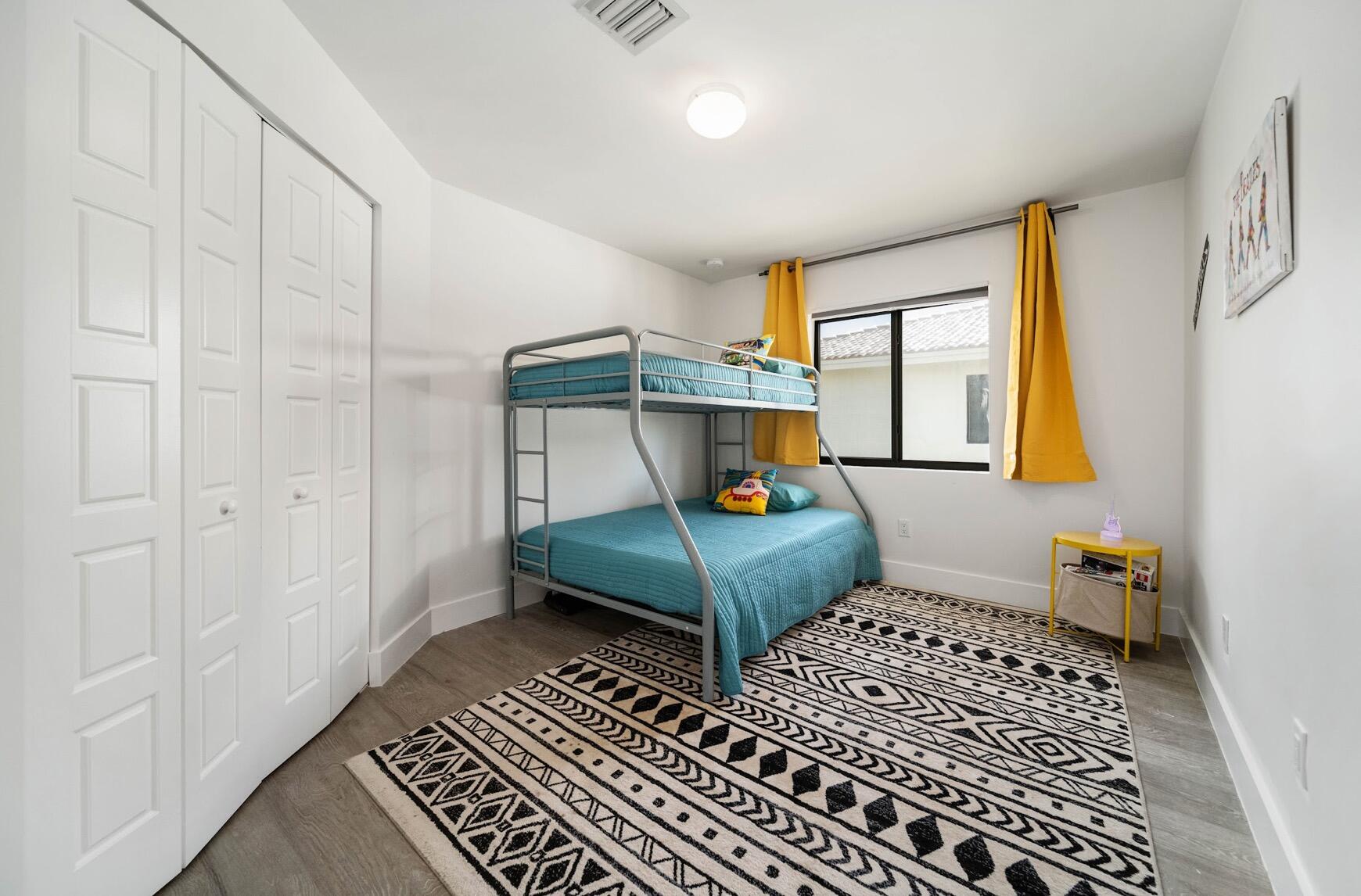 3254 Southwest 44th Street Fort Lauderdale, FL 33312 - Photo 19 of 26 a bedroom with a bed and wooden floor