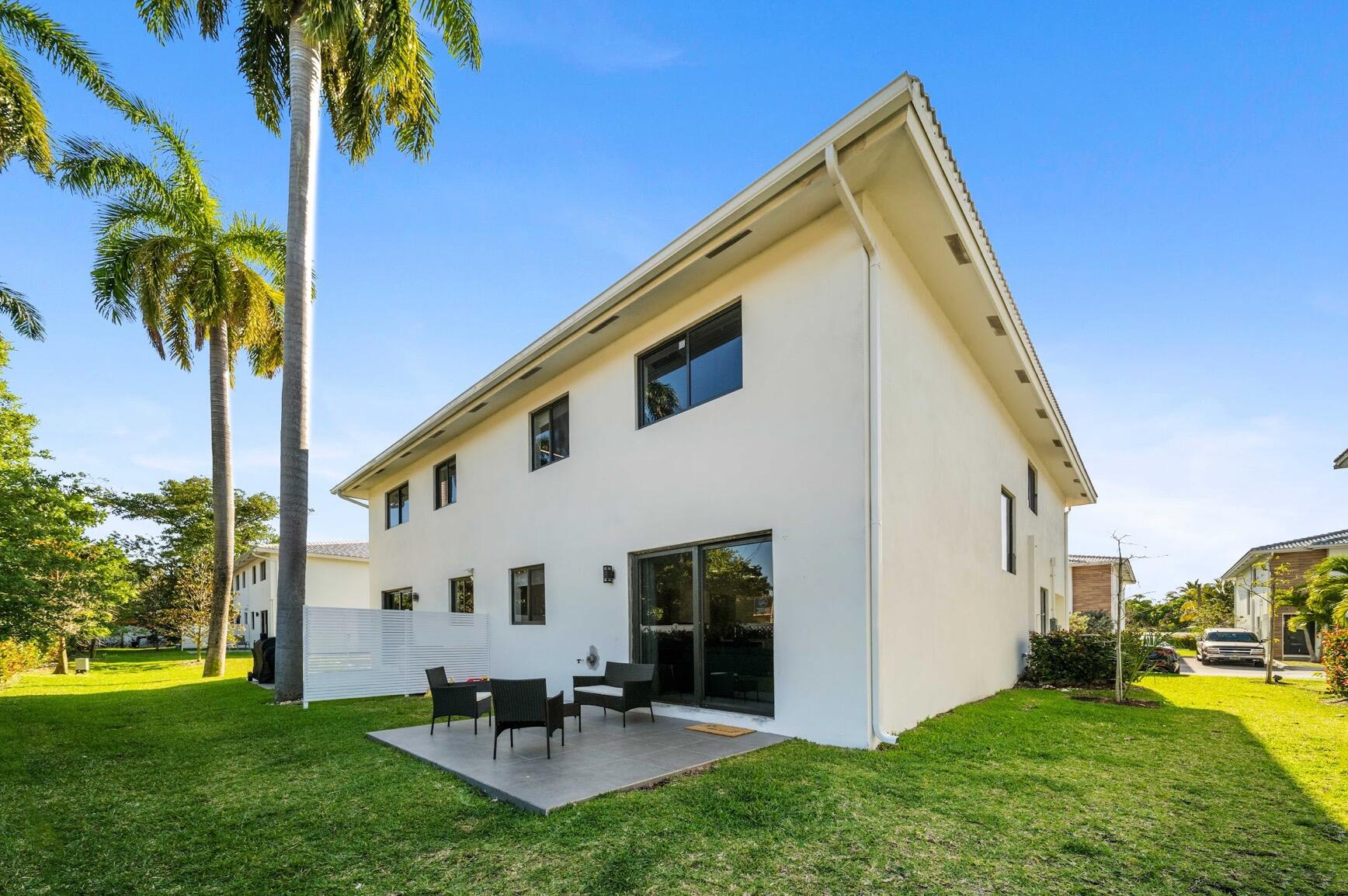 3254 Southwest 44th Street Fort Lauderdale, FL 33312 - Photo 21 of 26 a backyard of a house with table and chairs