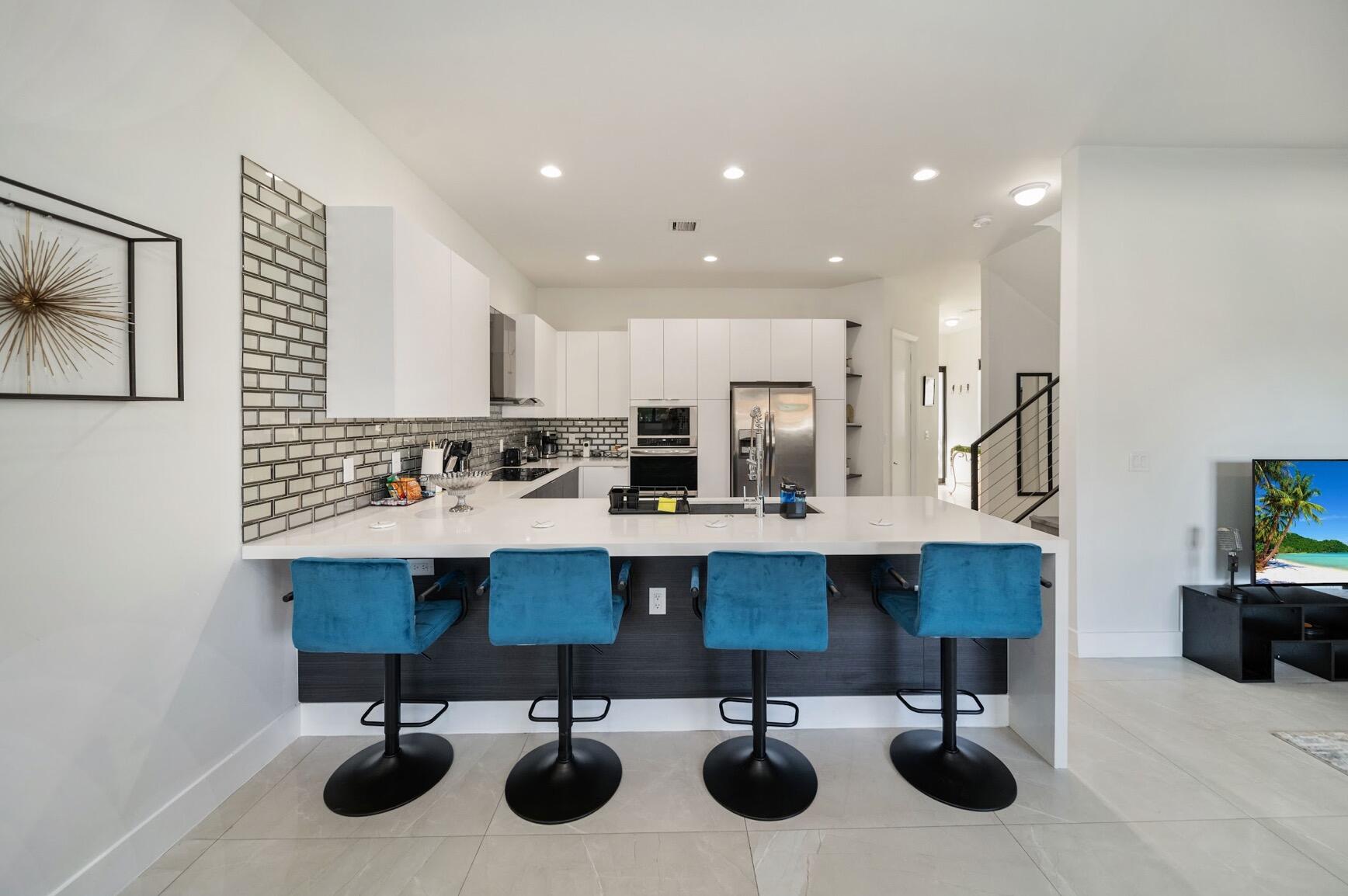 3254 Southwest 44th Street Fort Lauderdale, FL 33312 - Photo 6 of 26 a kitchen with stainless steel appliances kitchen island a sink and cabinets