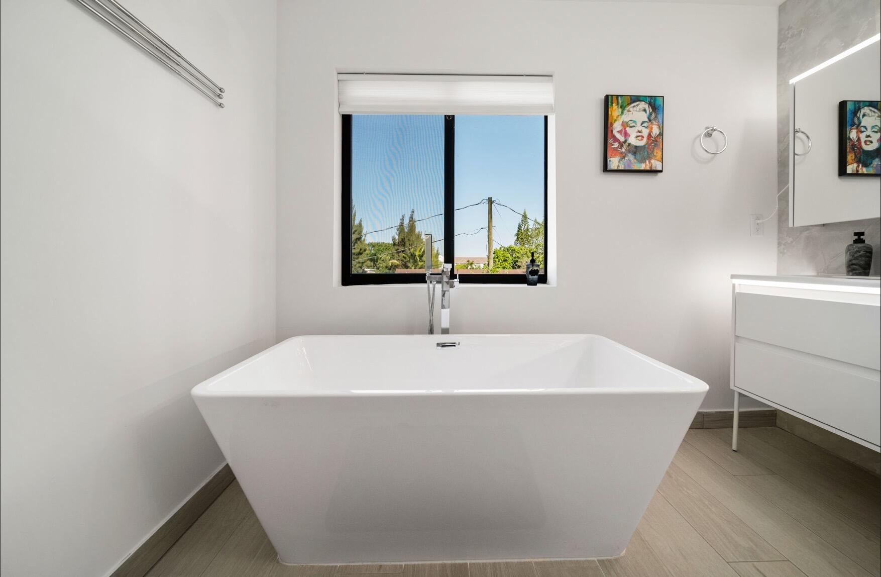 3254 Southwest 44th Street Fort Lauderdale, FL 33312 - Photo 9 of 26 a white bath tub sitting in a bathroom