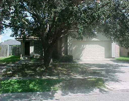 a house that has a tree in front of it