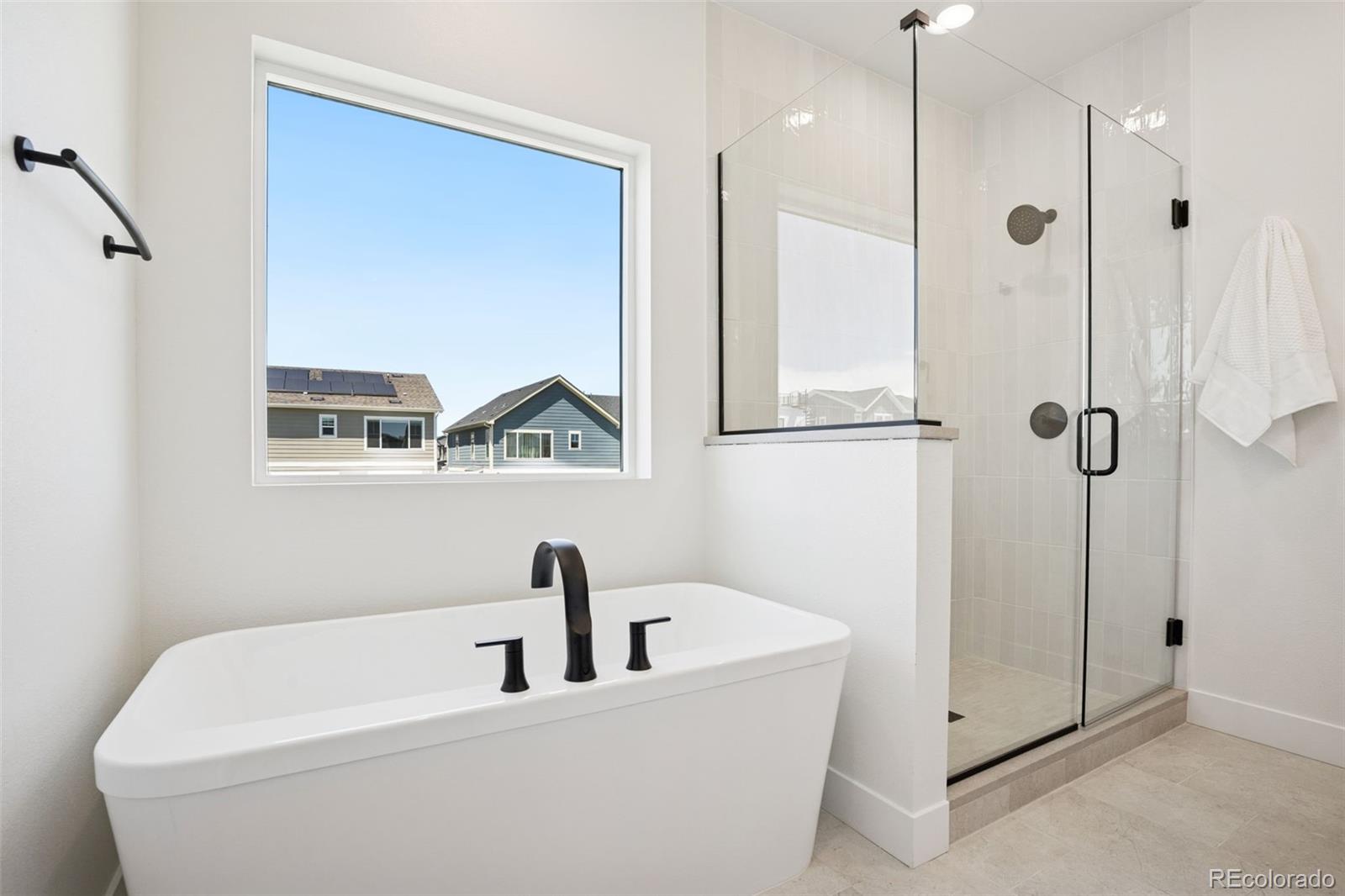 113 Mohawk Circle Superior, CO 80027 - Photo 19 of 50 a bathroom with a bathtub and a shower