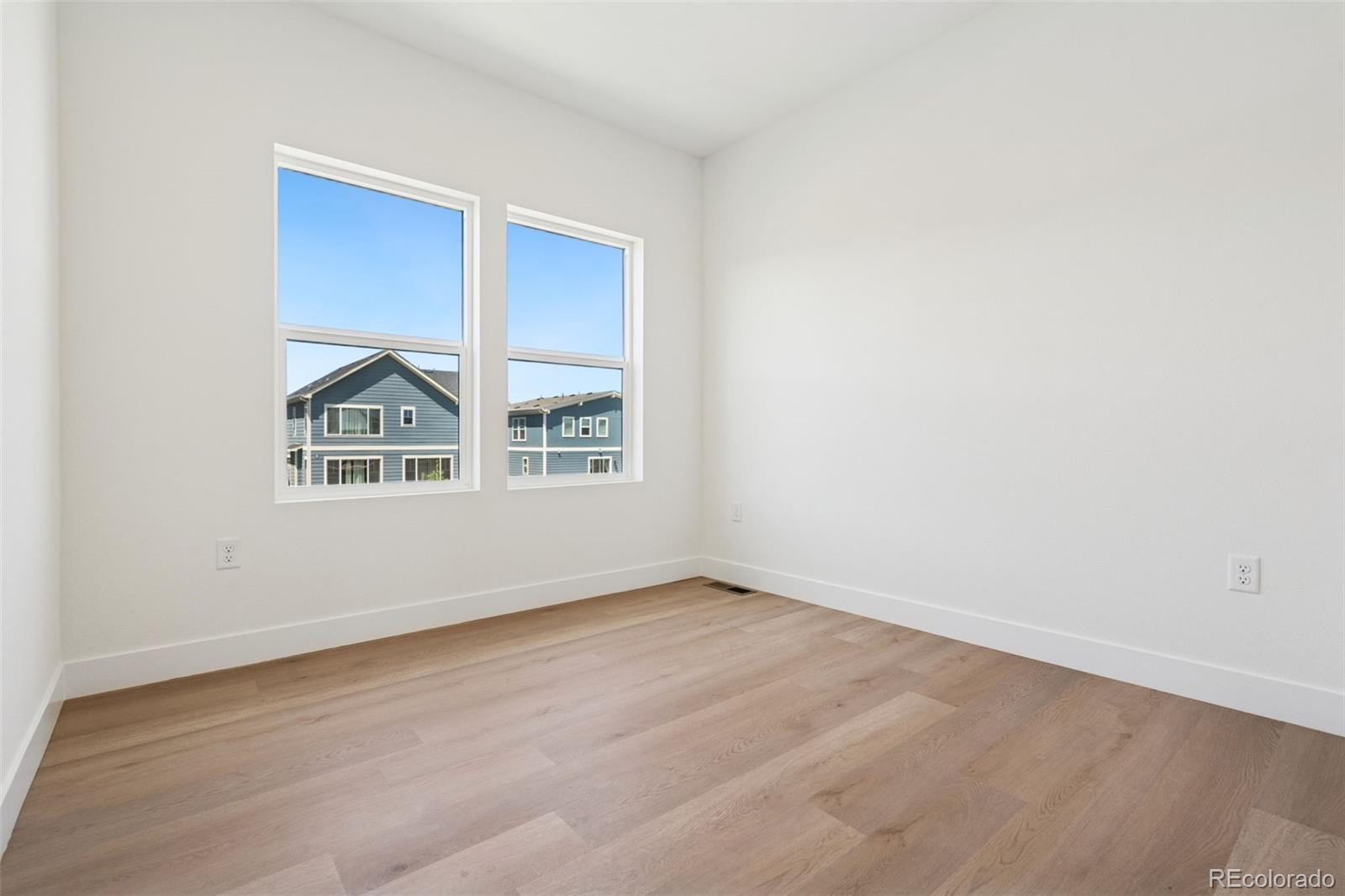 113 Mohawk Circle Superior, CO 80027 - Photo 25 of 50 an empty room with wooden floor and windows
