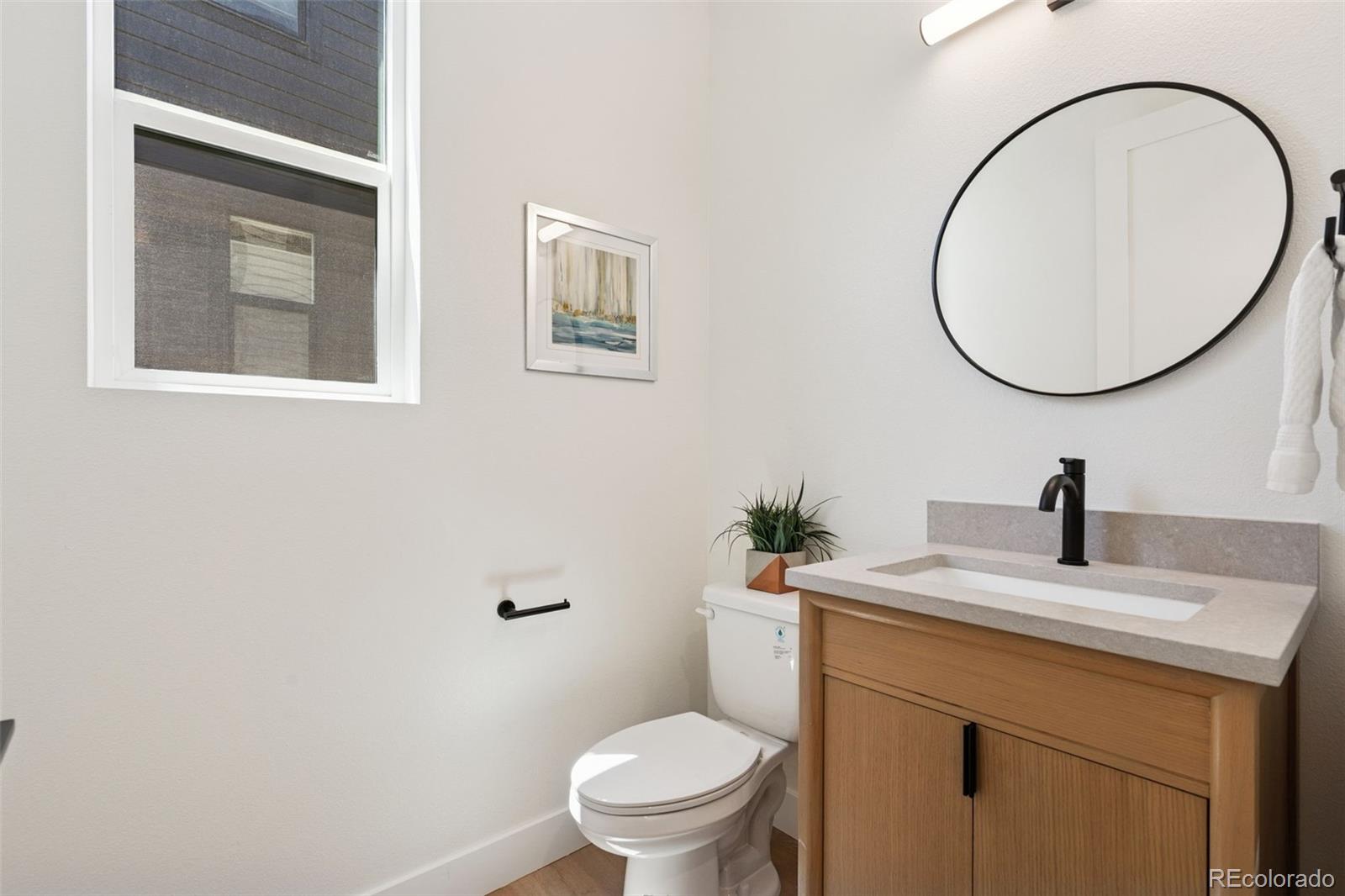 113 Mohawk Circle Superior, CO 80027 - Photo 28 of 50 a bathroom with a toilet a sink and mirror