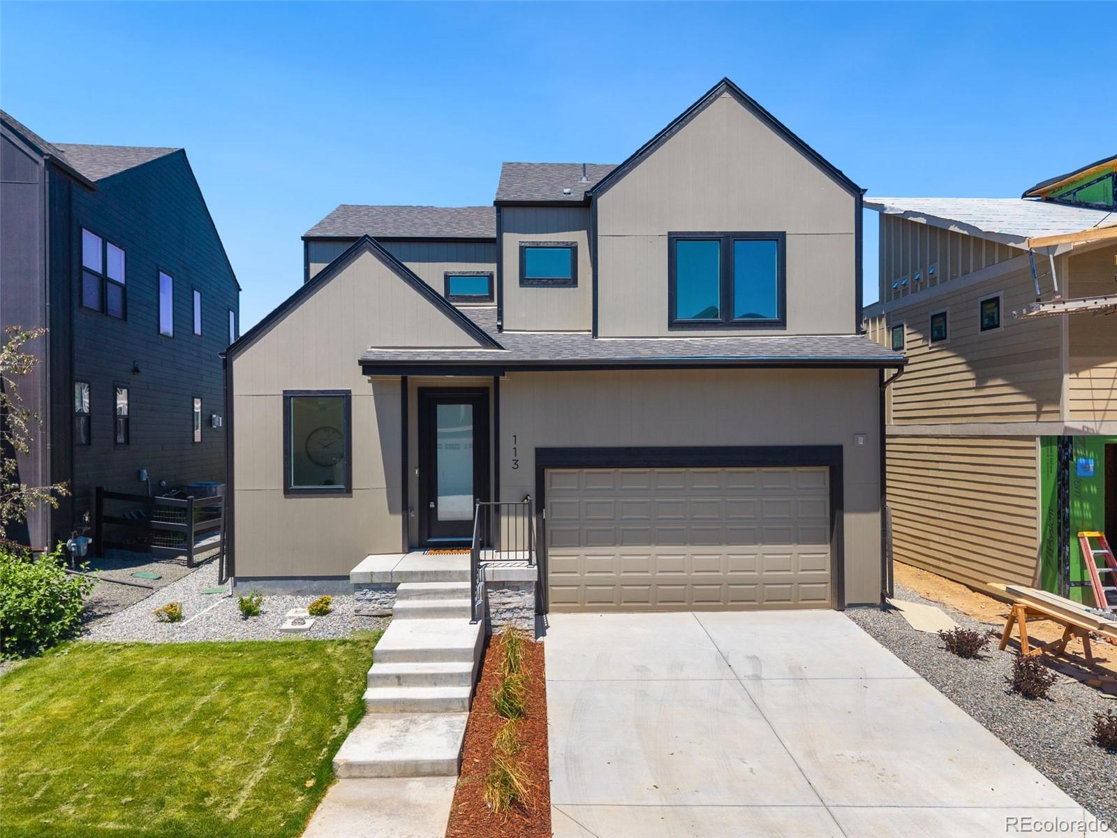 113 Mohawk Circle Superior, CO 80027 - Photo 3 of 50 a front view of a house with a yard and garage