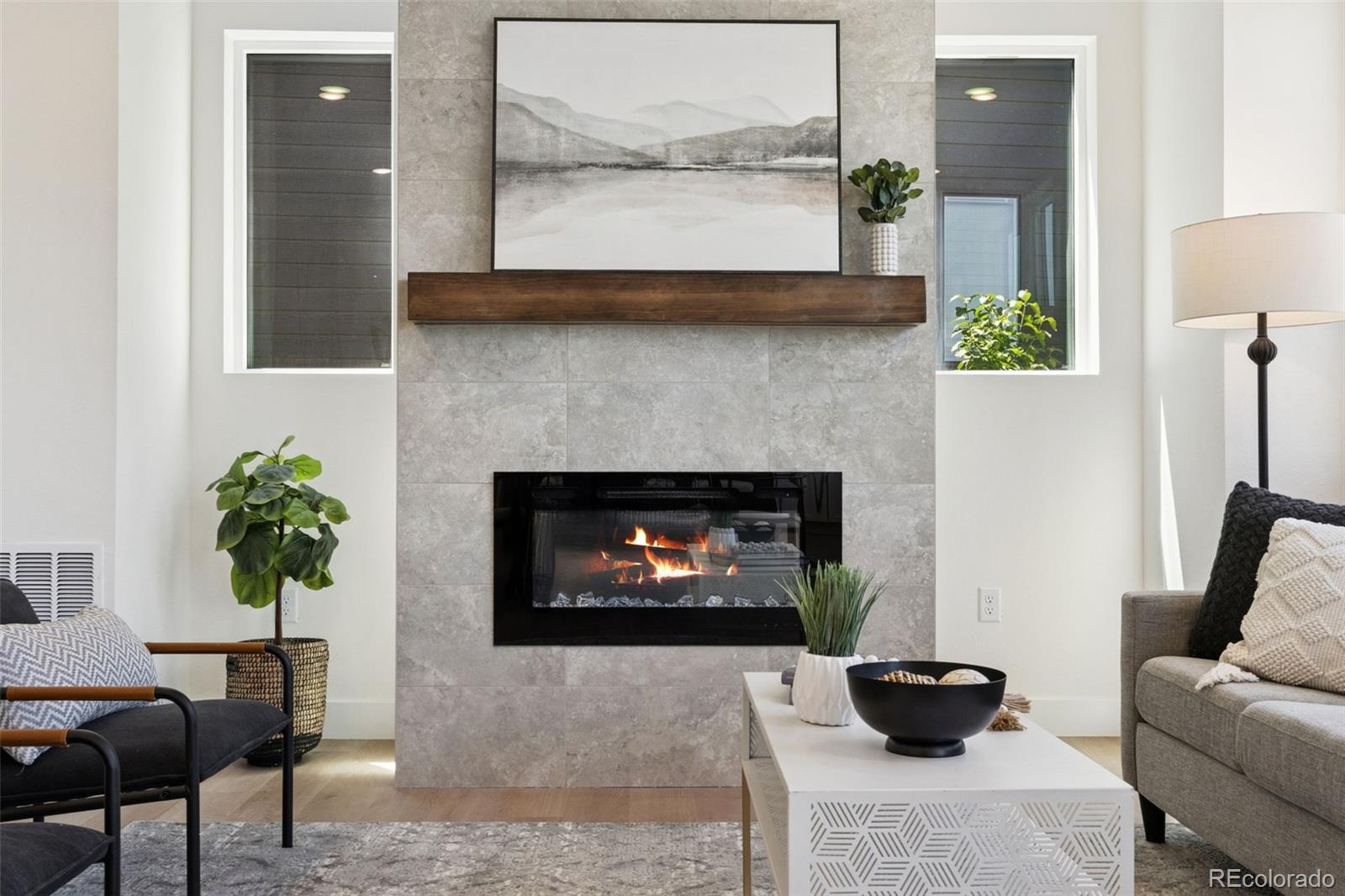 113 Mohawk Circle Superior, CO 80027 - Photo 8 of 50 a living room with a fireplace and a potted plant