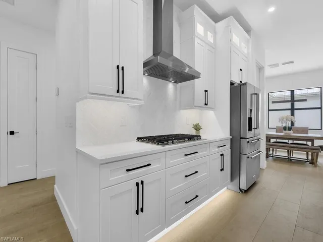 a kitchen with stainless steel appliances a stove and a refrigerator