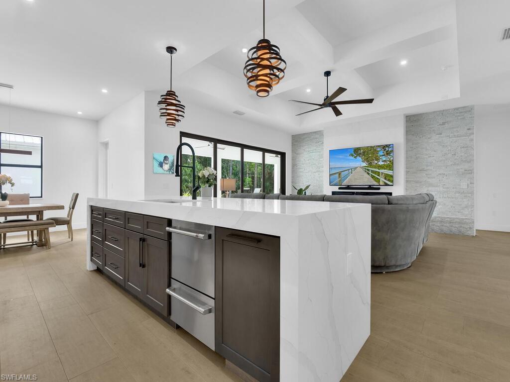 3475 3rd Avenue Southwest Naples, FL 34117 - Photo 12 of 49 a kitchen with stainless steel appliances kitchen island granite countertop a stove and a sink