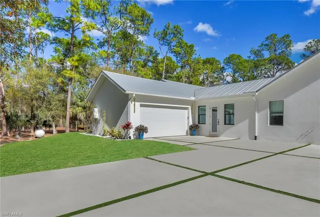 a bedroom with a bed window and a flat tv screen