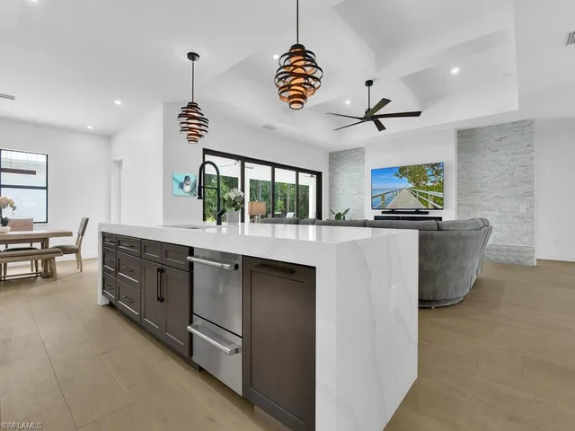 a bathroom with a granite countertop sink a toilet and shower