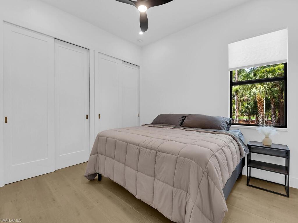 3475 3rd Avenue Southwest Naples, FL 34117 - Photo 20 of 49 a bedroom with a bed and a window