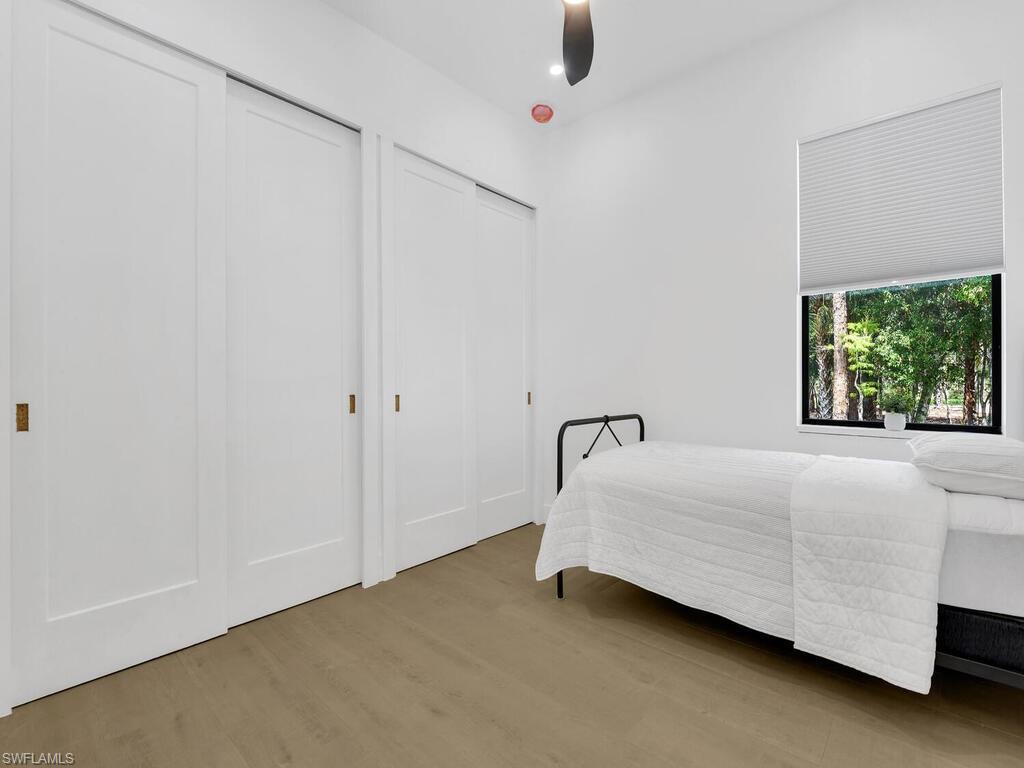 3475 3rd Avenue Southwest Naples, FL 34117 - Photo 22 of 49 a bedroom with a bed and a window