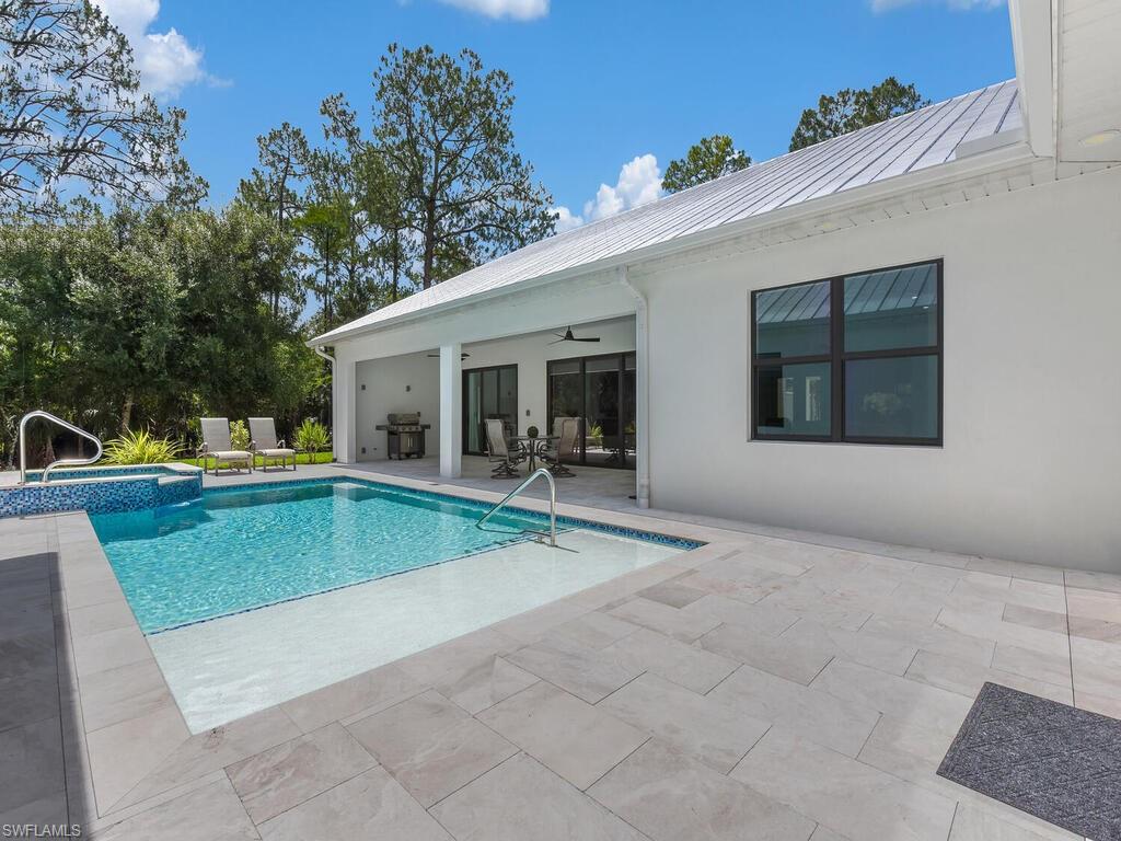 3475 3rd Avenue Southwest Naples, FL 34117 - Photo 25 of 49 a view of a house with a backyard and a patio