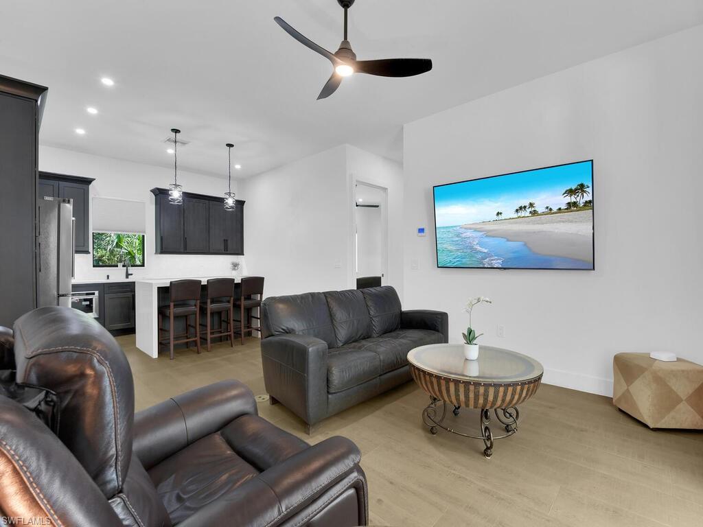 3475 3rd Avenue Southwest Naples, FL 34117 - Photo 26 of 49 a living room with furniture and a flat screen tv