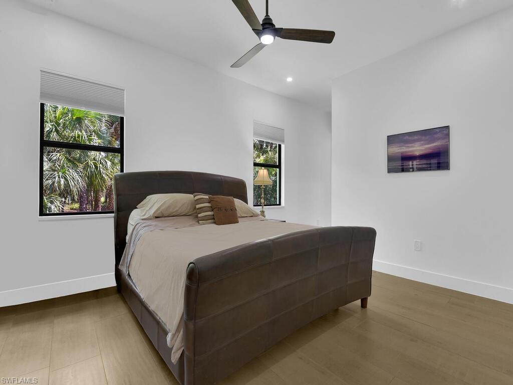 3475 3rd Avenue Southwest Naples, FL 34117 - Photo 31 of 49 a bedroom with a bed and a painting on the wall