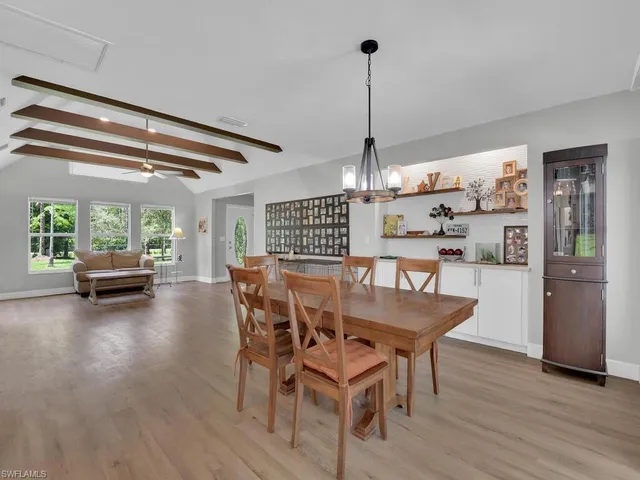 a kitchen with cabinets and wooden floor
