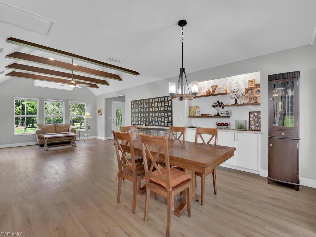 3475 3rd Avenue Southwest Naples, FL 34117 - Photo 36 of 49 a dining room with furniture and window