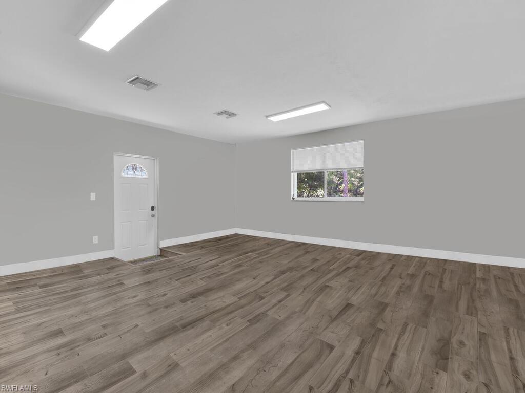 3475 3rd Avenue Southwest Naples, FL 34117 - Photo 39 of 49 an empty room with wooden floor and windows