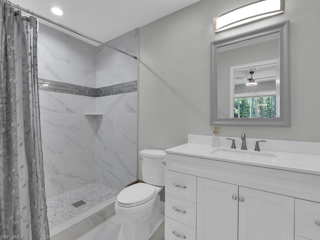 3475 3rd Avenue Southwest Naples, FL 34117 - Photo 43 of 49 a bathroom with a shower sink vanity mirror and toilet