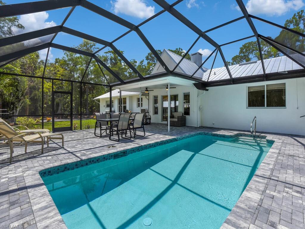 3475 3rd Avenue Southwest Naples, FL 34117 - Photo 44 of 49 an outdoor space with furniture and umbrella